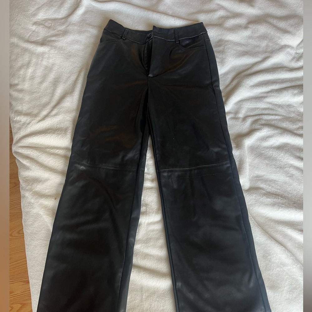 Black leather pants with cross knee detailing